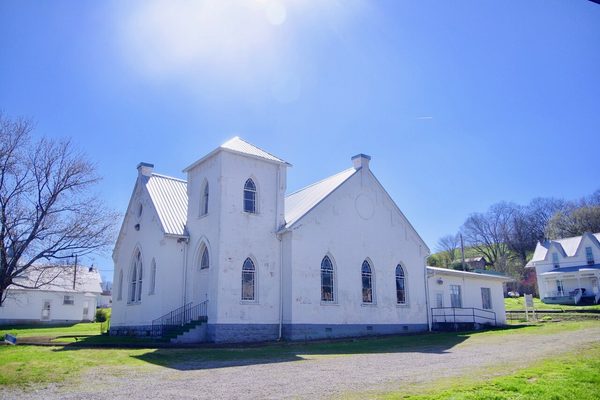 White frame church with a square bell tower and a gabled front