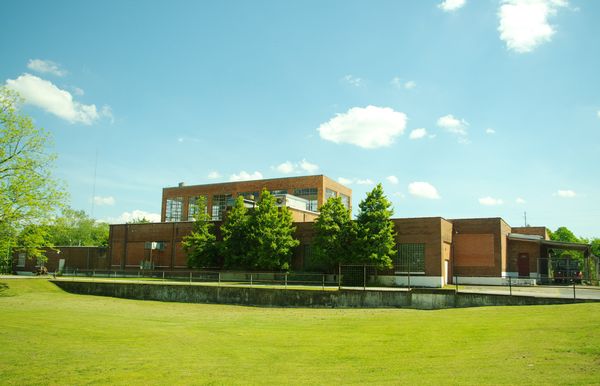 Long low brick building of the former Borden milk plant, now the county museum, behind a green lawn