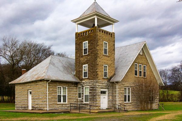 Stone schoolhouse with a square bell tower
