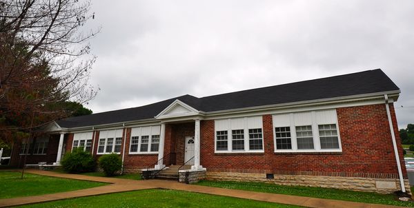 Long one-story brick school building with a central entrance