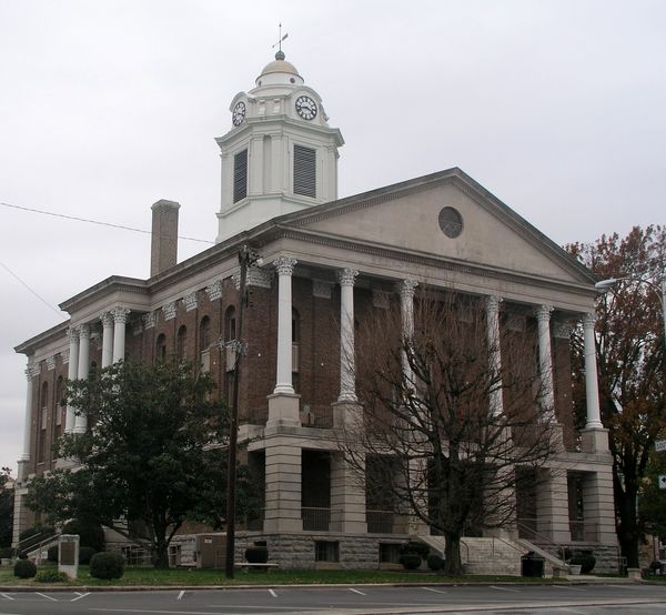 The Bedford County Courthouse, with tall white columns and a white cupola with a clock