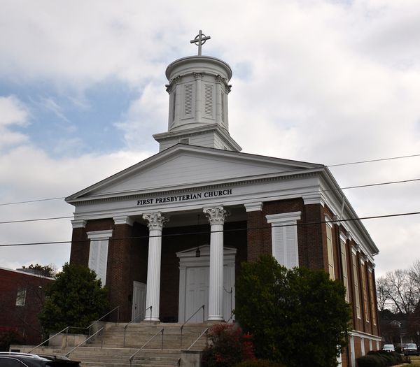 A brick church with a tall steeple