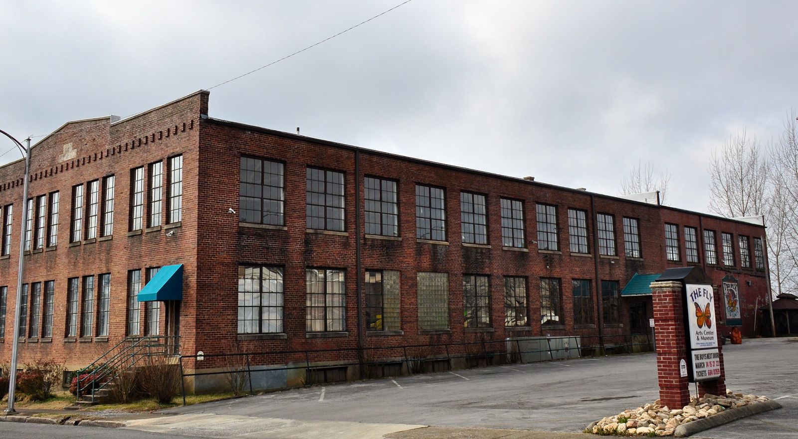 A brick commercial and factory building on a downtown street