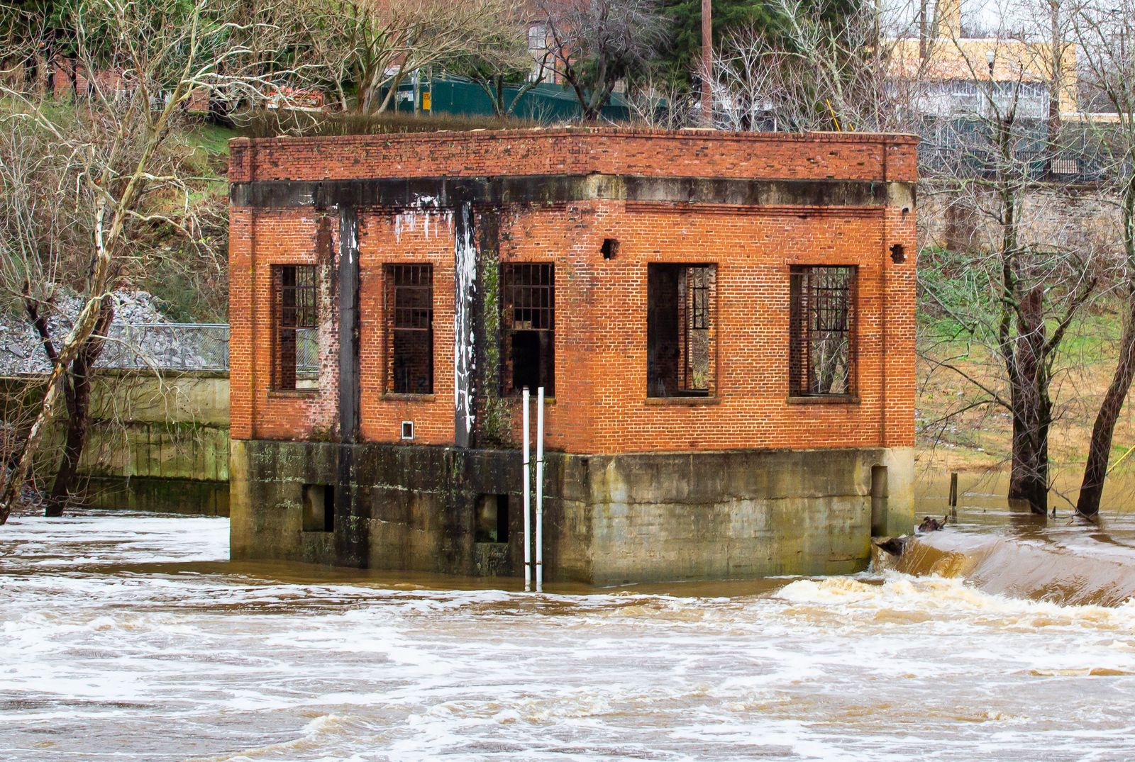A small brick powerhouse beside the fast-moving Duck River