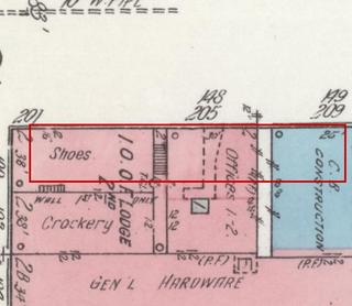 April 1914 Sanborn fire insurance map detail with the lot at today&rsquo;s 100 Elk Ave. S. (storefront 2 of 2) outlined in red; the map labels it: shoes