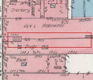 April 1914 Sanborn fire insurance map detail with the lot at today&rsquo;s 106 Elk Ave. S. (storefront 2 of 2) outlined in red; the map labels it: drugstore