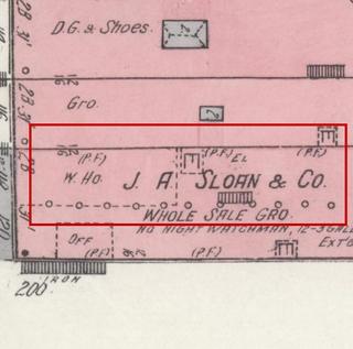 April 1914 Sanborn fire insurance map detail with the lot at today&rsquo;s 110 Elk Ave. S. (storefront 1 of 5) outlined in red; the map labels it: j. a. sloan & co., wholesale grocery