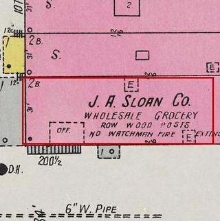 September 1926 Sanborn fire insurance map detail with the lot at today&rsquo;s 110 Elk Ave. S. (storefront 1 of 5) outlined in red; the map labels it: j. a. sloan co., wholesale grocery